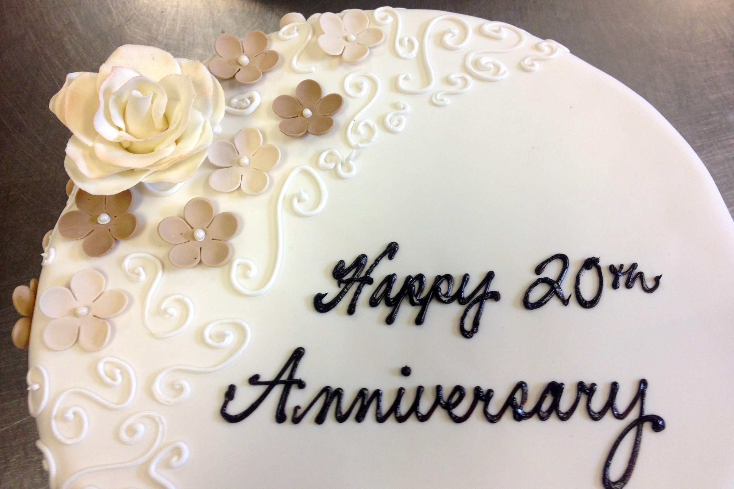 White anniversary cake with piped swirls