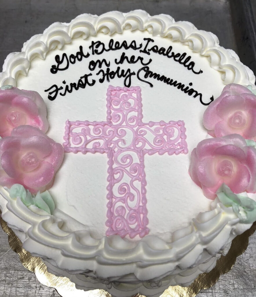 Communion cake that reads "God Bless Isabella on her First Holy Communion"