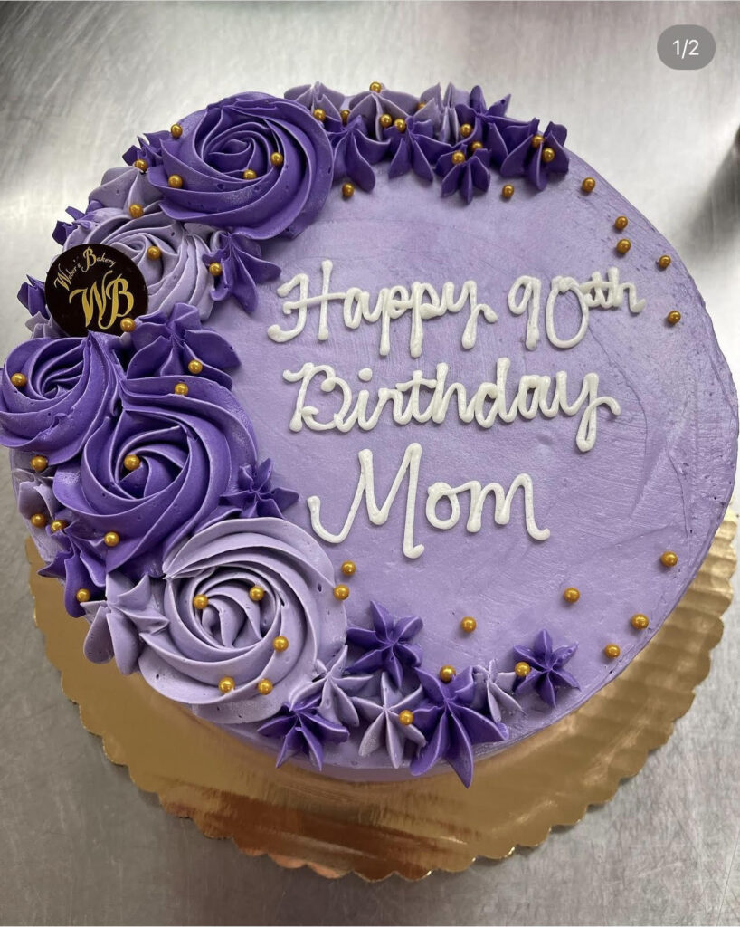 Purple cake that reads "Happy 90th Birthday Mom"