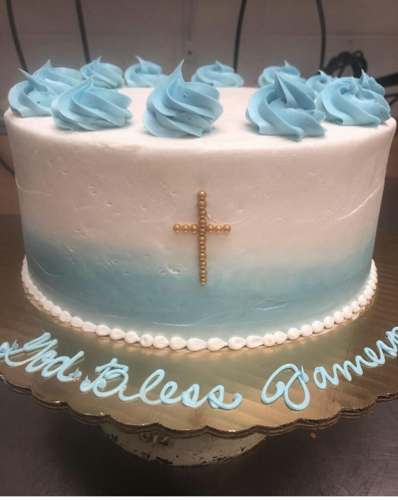 White and blue communion cake with cross